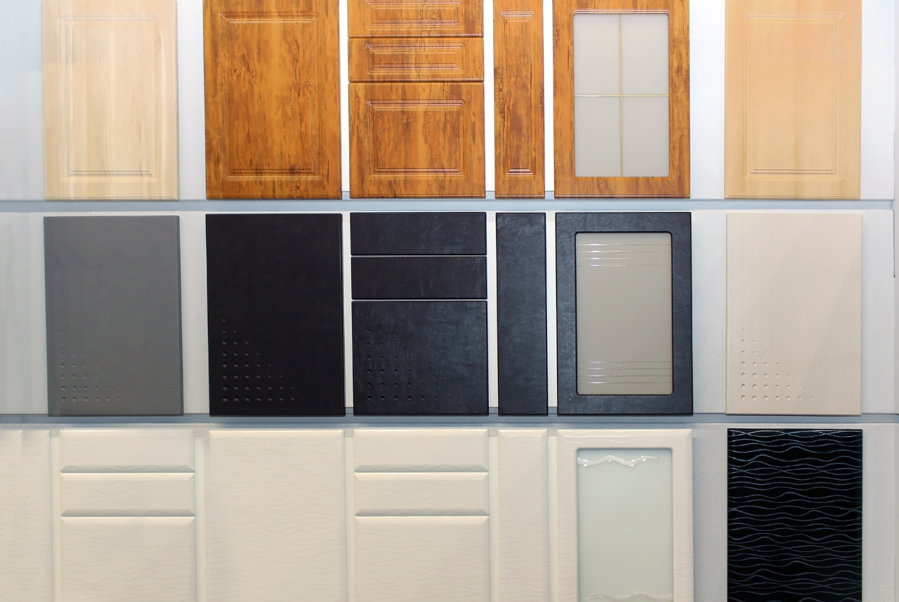 Alpine Custom Cabinets - Display of various cabinet door designs and finishes for custom kitchen options.