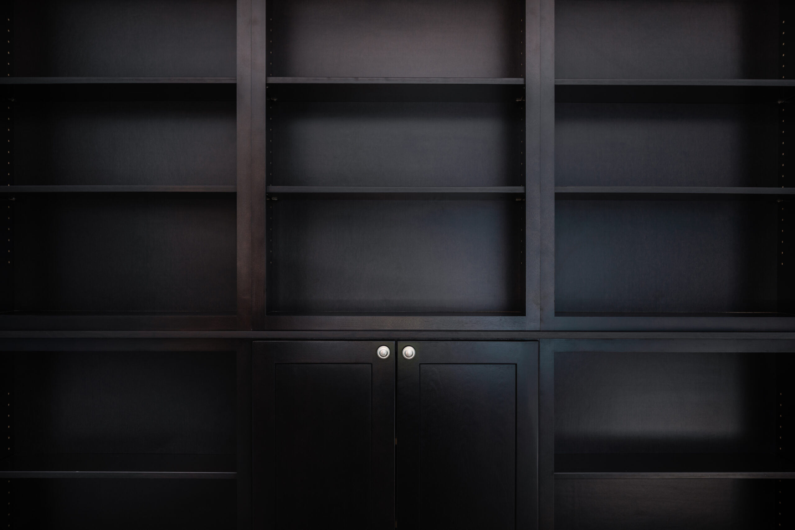 Empty Bookcase in a Remodeled Library Empty wooden, espresso colored bookshelves in a newly remodeled home library
